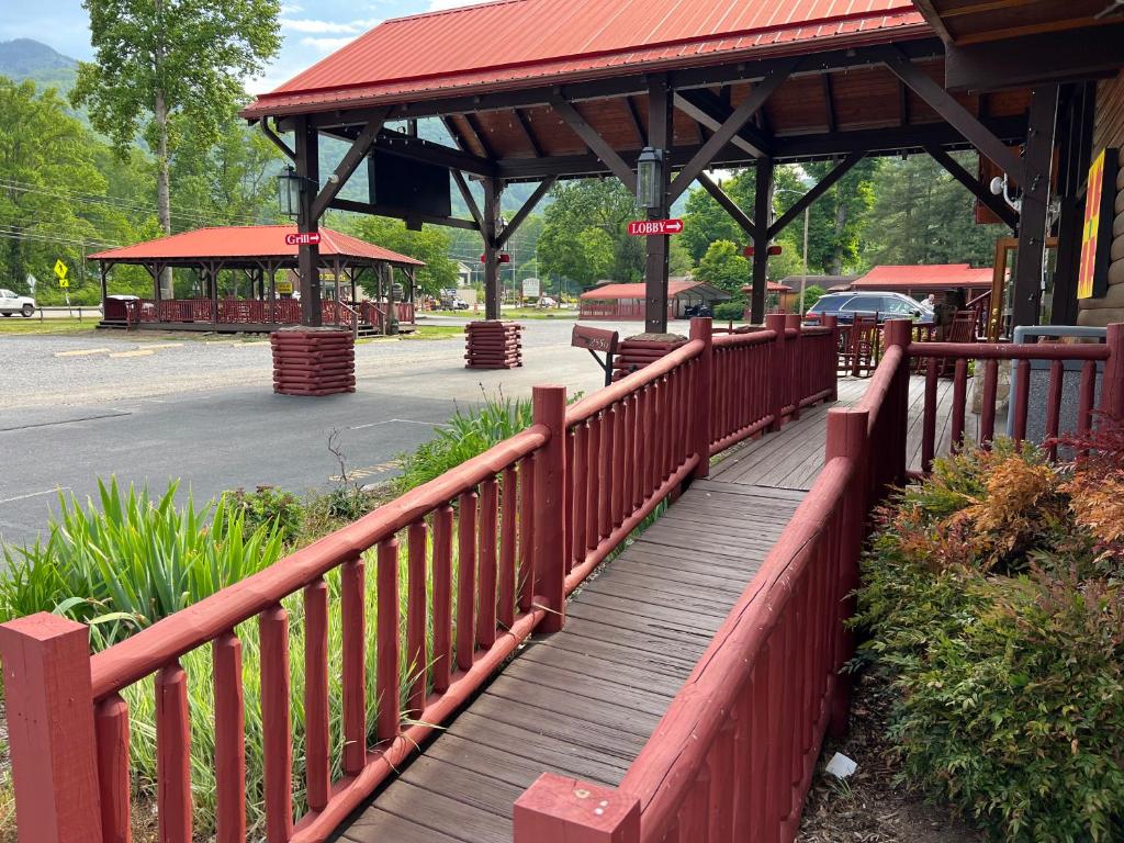 a wooden boardwalk in front of a train station at Smoky Falls Lodge in Maggie Valley