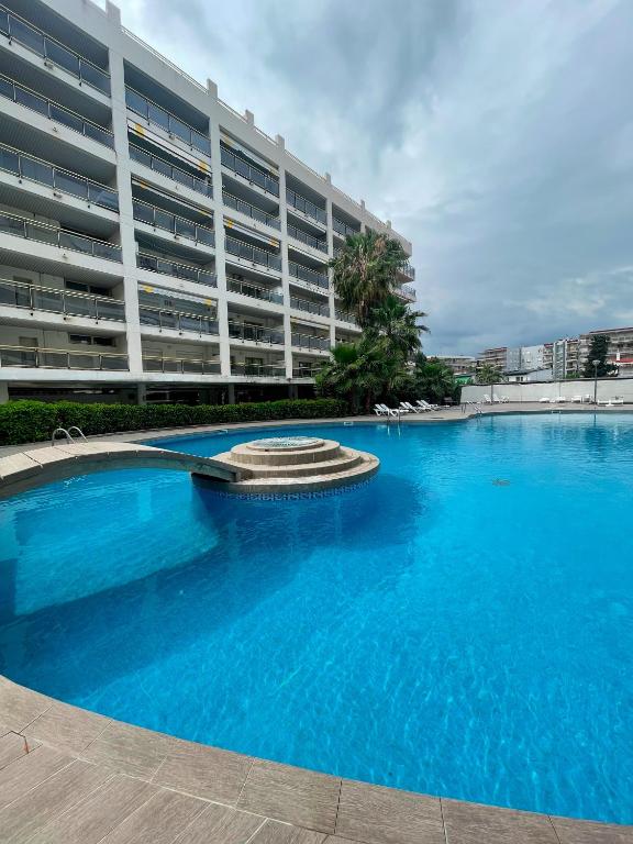 a large swimming pool in front of a large building at RESIDENCIAL MICHELANGELO in Salou