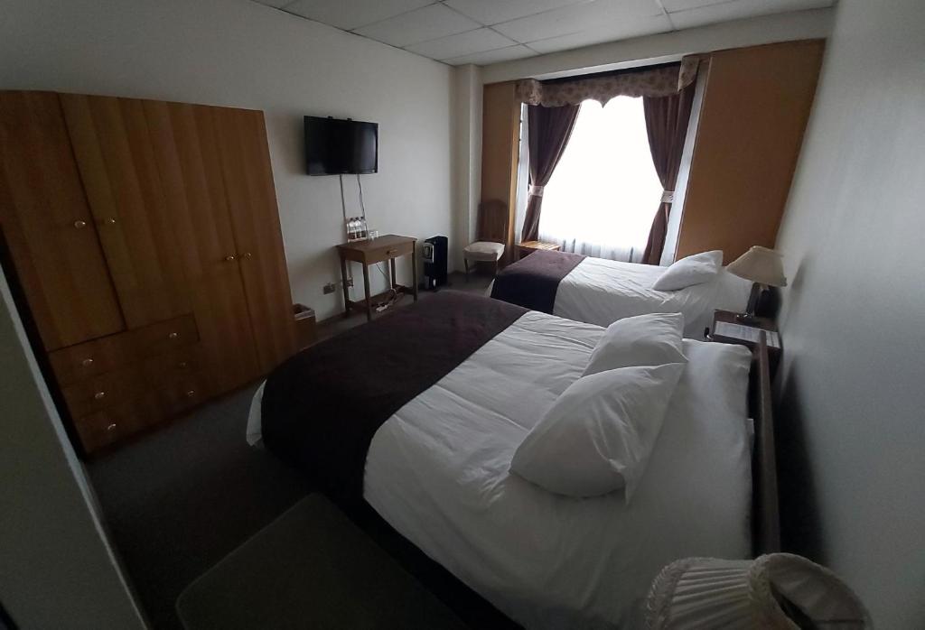 Postel nebo postele na pokoji v ubytování Hotel Esmeralda
