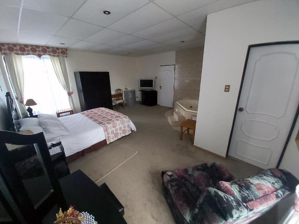 Postel nebo postele na pokoji v ubytování Hotel Esmeralda