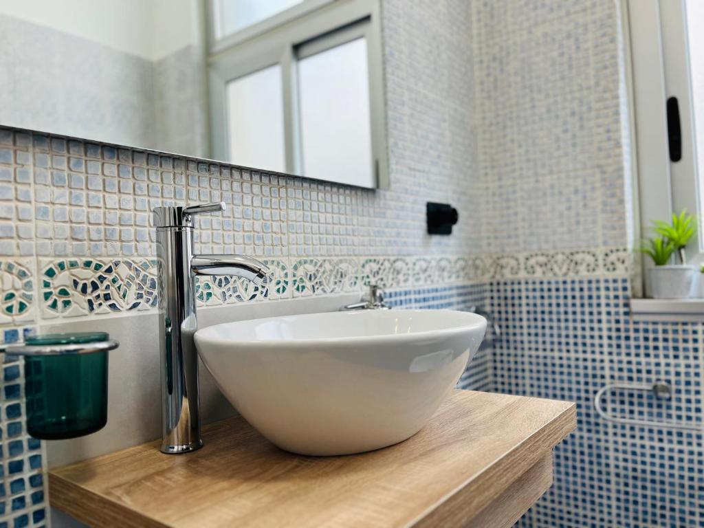 a bathroom with a white sink and a mirror at Le Dimore del Corso in Catania