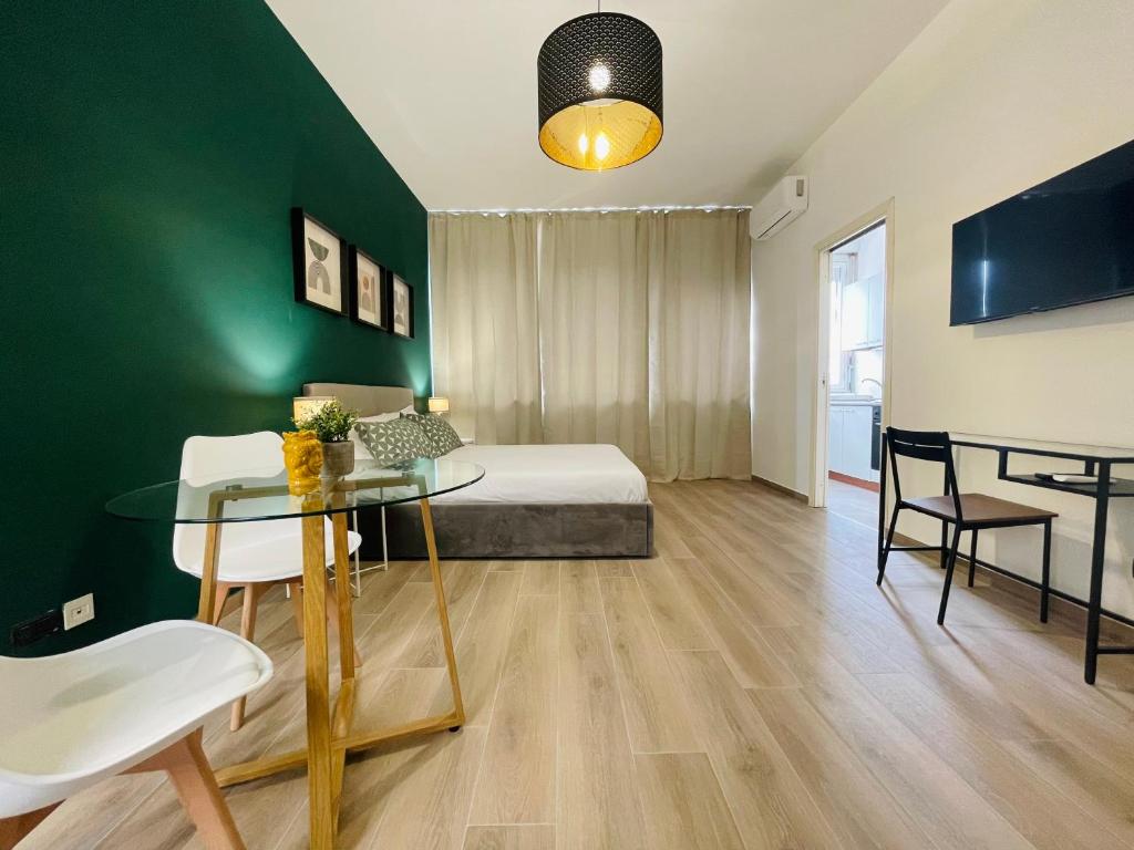 a room with a bed and a table and chairs at Le Dimore del Corso in Catania