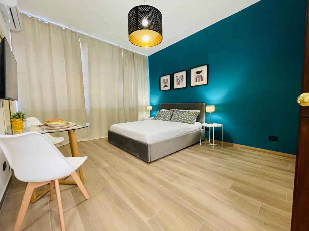 una camera con letto e parete blu di Le Dimore del Corso a Catania