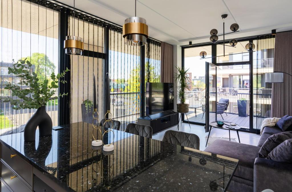 a living room with a couch and a table at Liine apartment 3027 in Pärnu