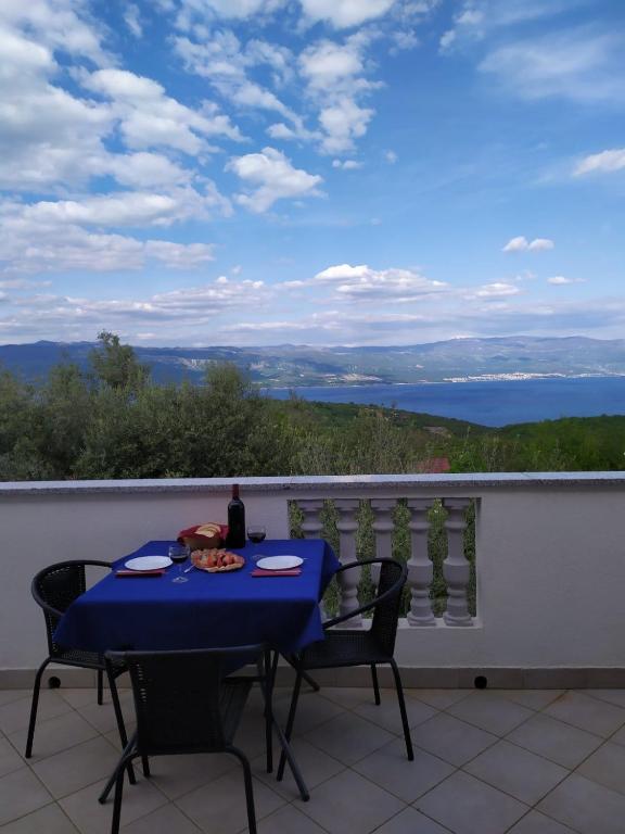 a blue table and chairs on a balcony with a view at Apartmani Danica in Risika