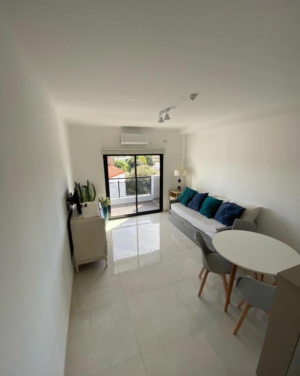 a living room with a couch and a table at Dpto Temporario Corrientes in Corrientes