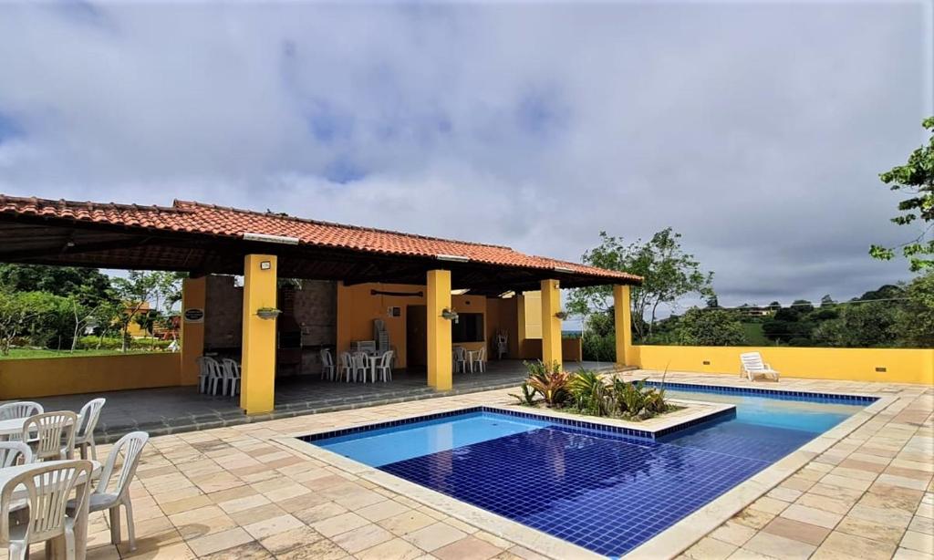 a villa with a swimming pool and a patio at Flat Paraíso em Serra Negra- Bezerros/PE in Bezerros