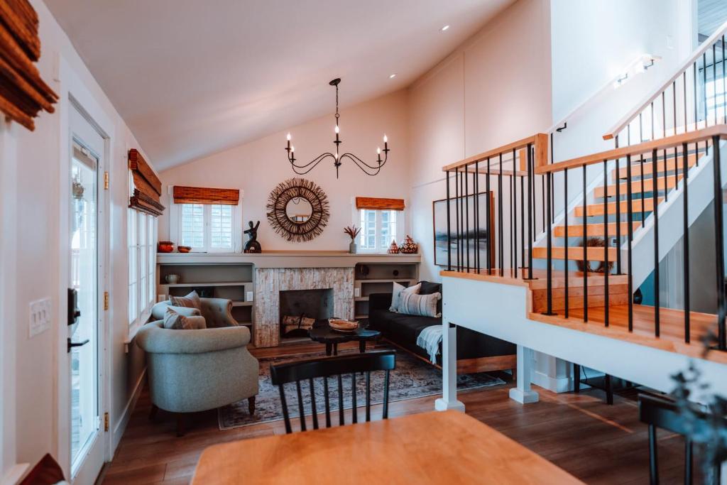 a living room with a staircase and a fireplace at Swank House on Main St in Ashland in Ashland