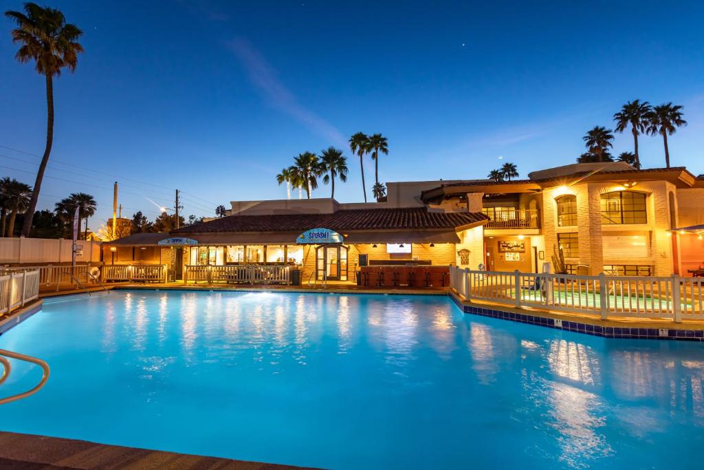 a large swimming pool in front of a house at Scottsdale Camelback Resort in Scottsdale