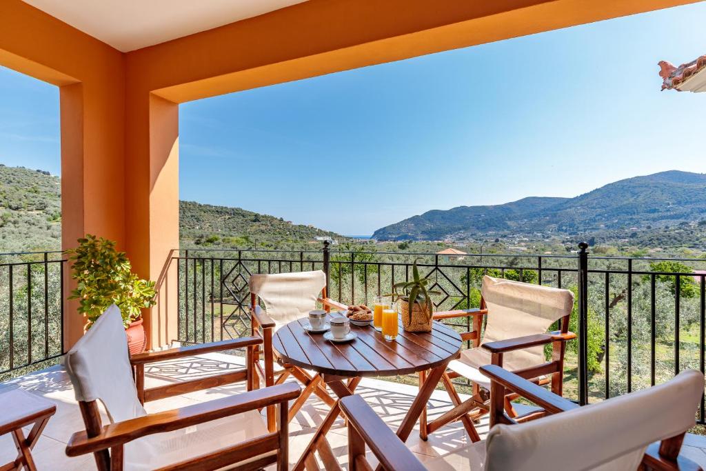 a patio with a table and chairs on a balcony at Eleonora's in Skopelos Town