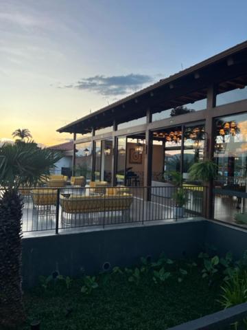 a building with chairs and tables in front of it at Resort Quinta Santa Bárbara in Pirenópolis