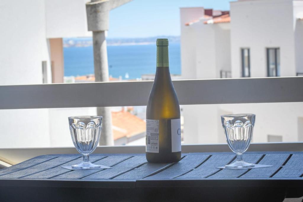 a bottle of wine and two glasses on a table at EastView Lagos in Lagos