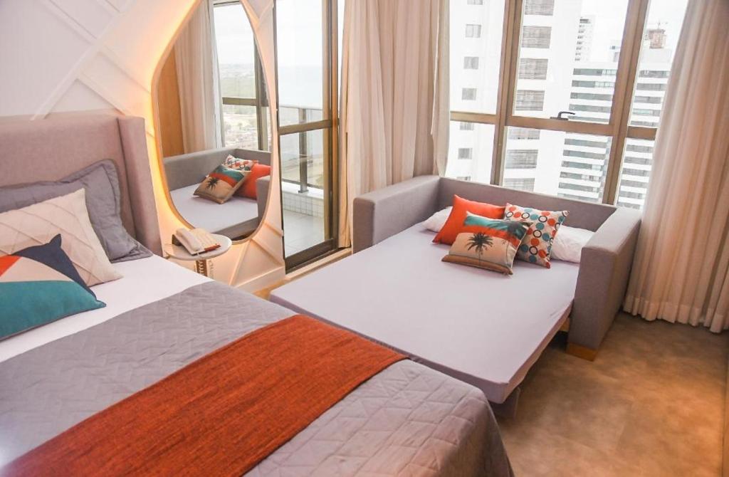 a hotel room with a bed and a window at VISTA MAR BOA VIAGEM - BEACH CLASS EXECUTIVE in Recife