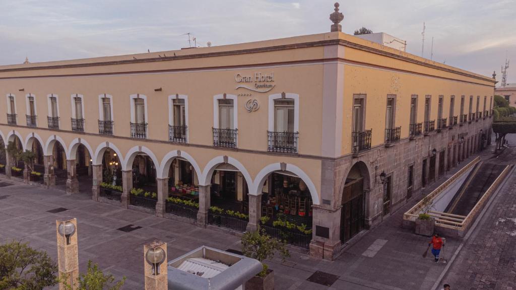 a large building with a fountain in front of it at Gran Hotel de Querétaro in Querétaro