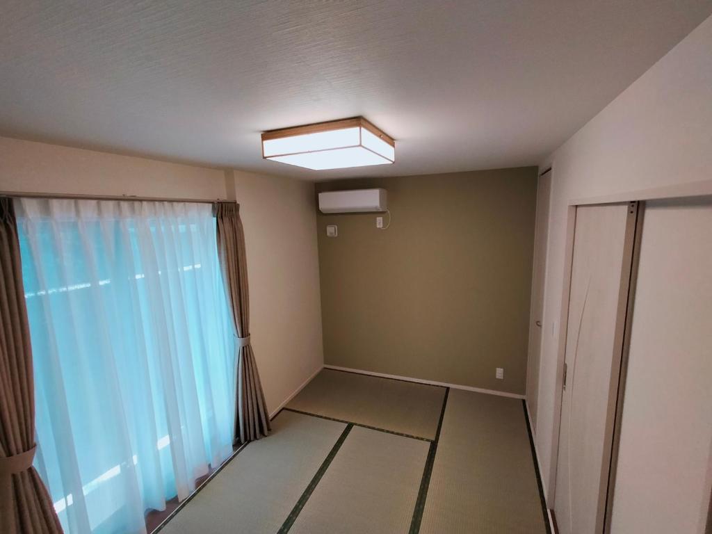 Postel nebo postele na pokoji v ubytování FunHome黒川