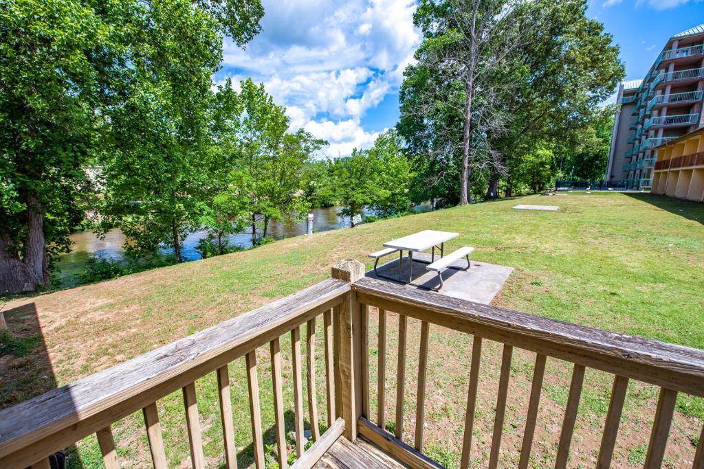 a balcony with a picnic table and a park at Cabin Close to parkway rd with River View in Pigeon Forge