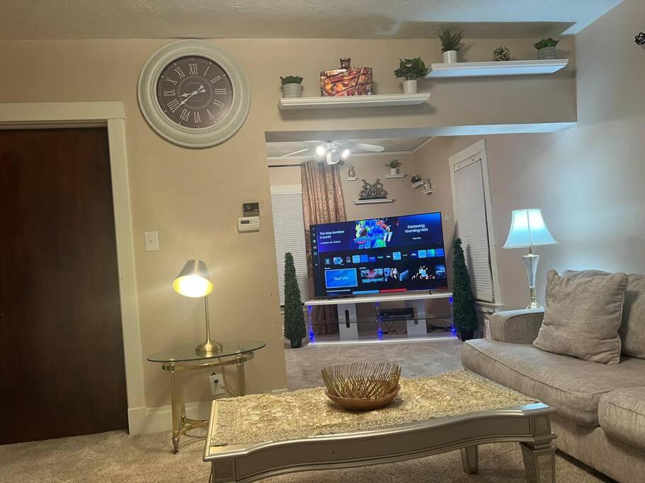 a living room with a couch and a flat screen tv at Bel apartment in Sioux City