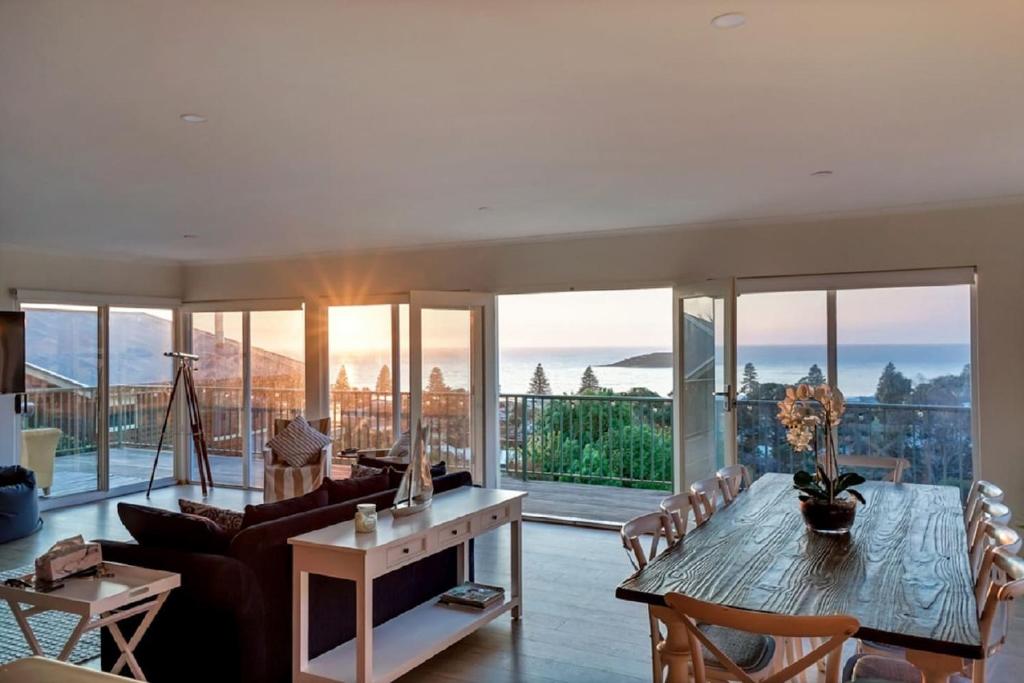 a living room with a table and a couch at Uninterrupted Views Encounter Bay - BYO Linen in Encounter Bay