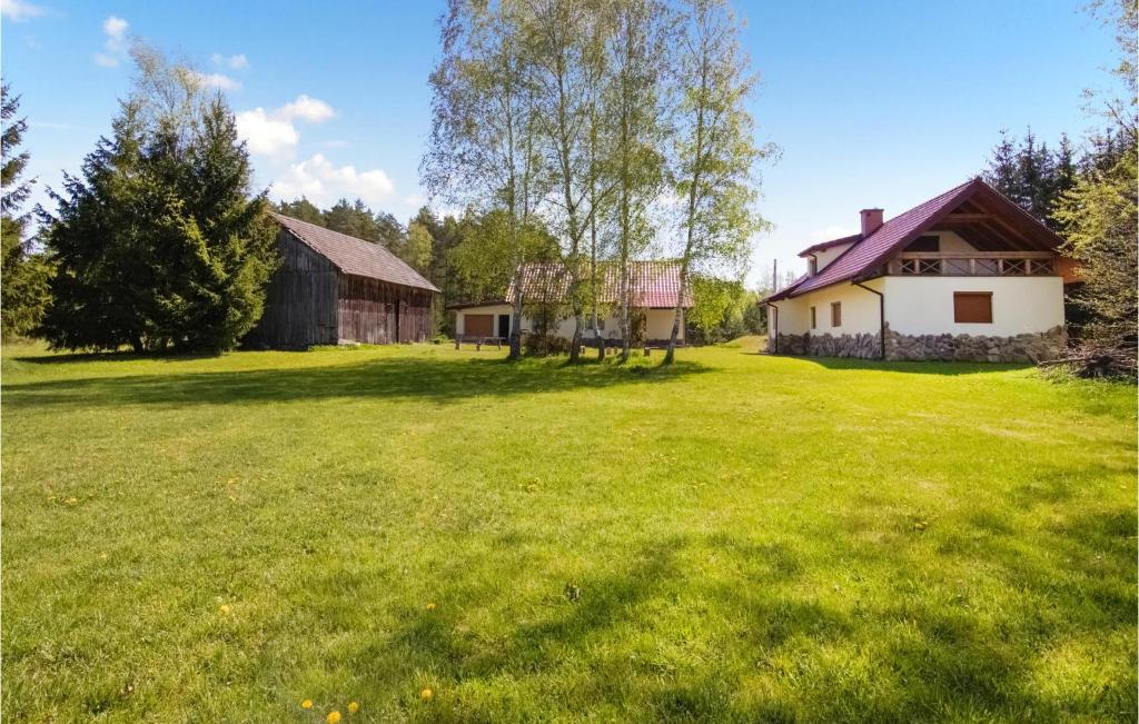 a large yard with a barn and a house at Pet Friendly Home In Szczytno With Wifi in Szczytno