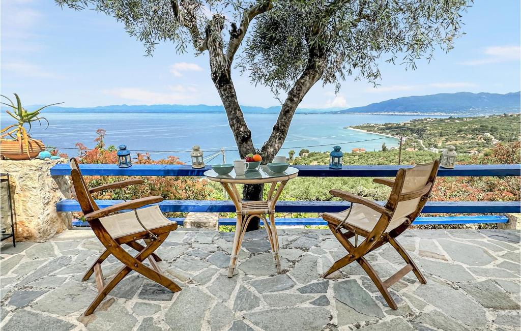 a table and chairs with a view of the ocean at 2 Bedroom Lovely Home In Kalamata in Kalamata