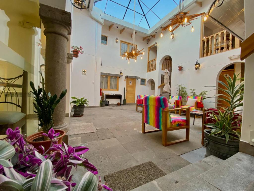 a room with plants and chairs and a fireplace at Mistico San Blas Boutique in Cusco