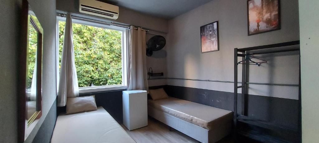 a small room with a bench and a window at Hostel Leblon in Rio de Janeiro