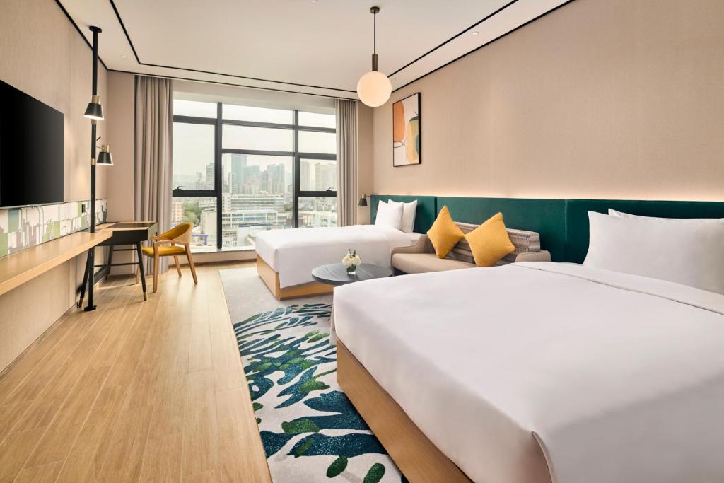 Postel nebo postele na pokoji v ubytování Hilton Garden Inn Zhuhai Jinan University