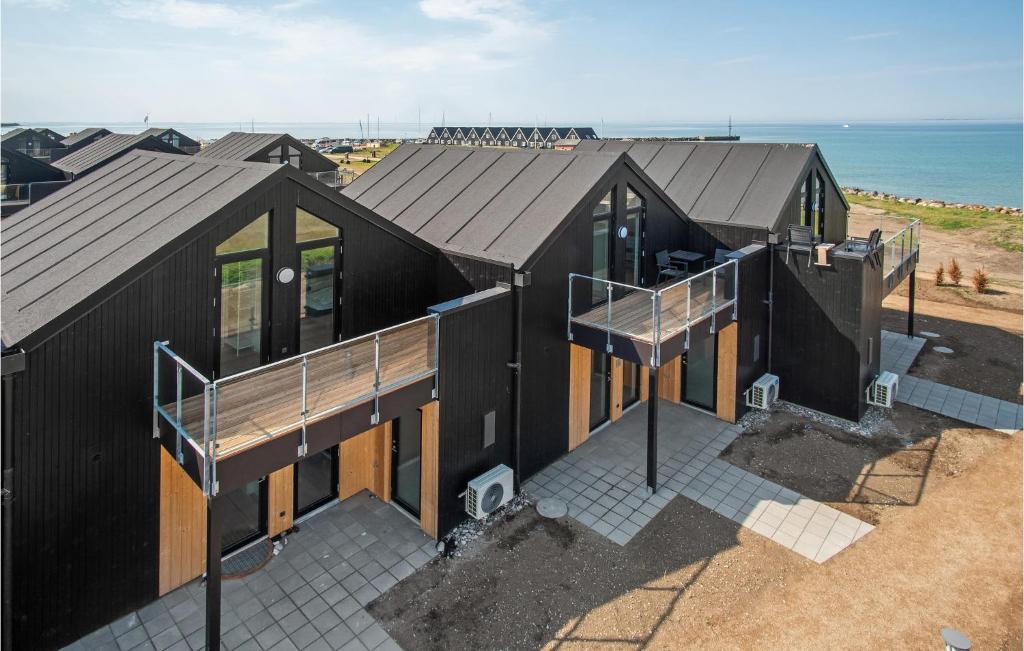 an overhead view of a black house on the beach at Kysthusene in Engvang