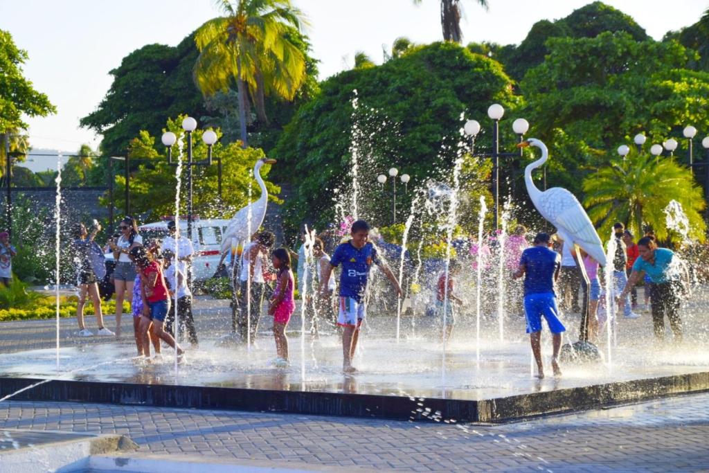 a group of children playing in a fountain at Casa Yoly Hostel Granada in Granada