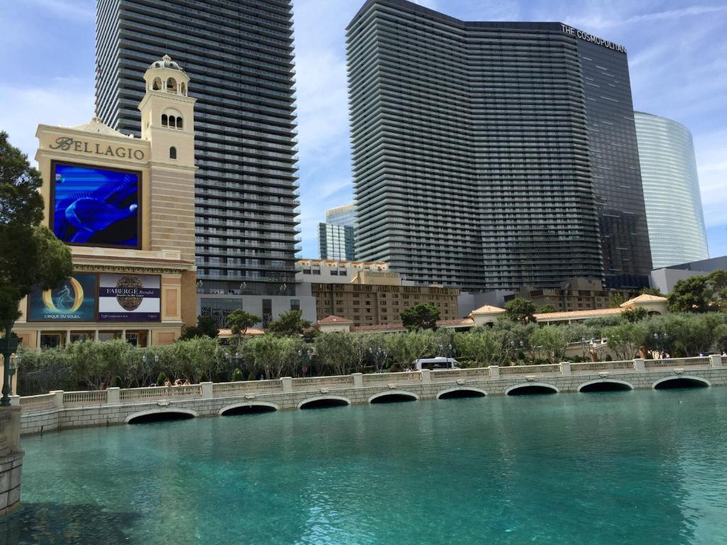 a bridge over a river in a city with tall buildings at Jockey Resort Suites Center Strip in Las Vegas
