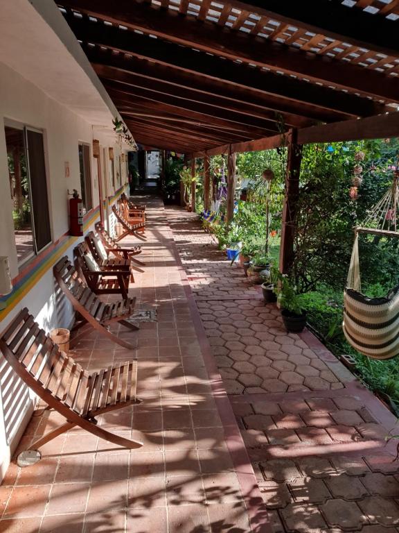 a row of benches sitting on a patio at Cabañas Colibrí in Bacalar