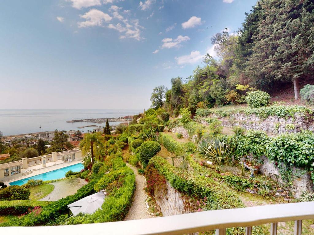 a view from the balcony of a house with a swimming pool at Grand 3P à Menton avec terrasses et parkings - FR-1-196-331 in Menton