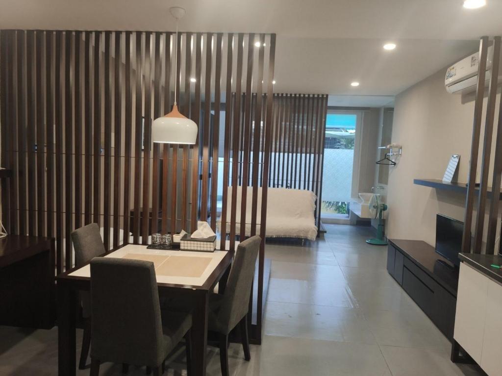 a kitchen and dining room with a table and a bed at Morden Bathtub Apartment in Ho Chi Minh City