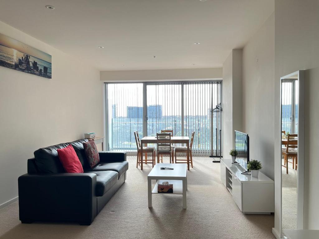 a living room with a couch and a table at Tasha's Apartments on Morphett in Adelaide