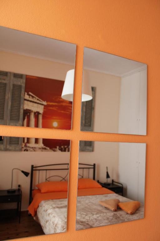 a bedroom with a bed and two mirrors at Petaluda House 1 in Athens