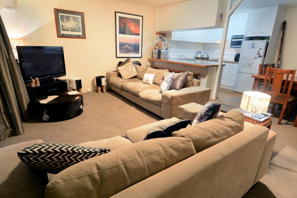 a living room with a couch and a tv at Molony's 12 in Mount Buller