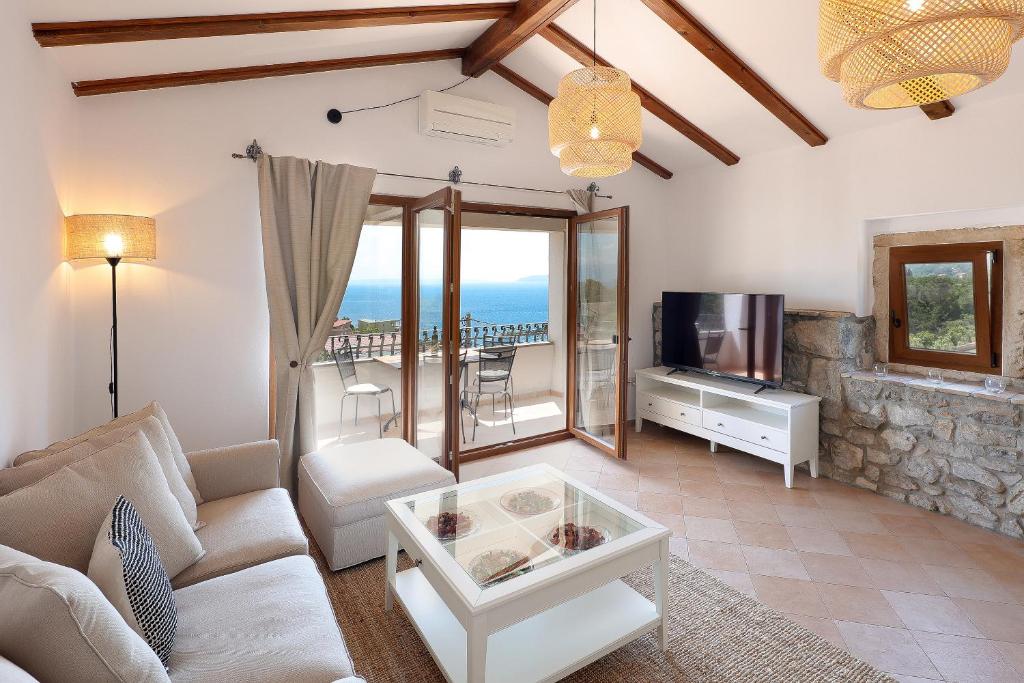 a living room with a couch and a tv at Villa Fani with Jacuzzi in Ičići