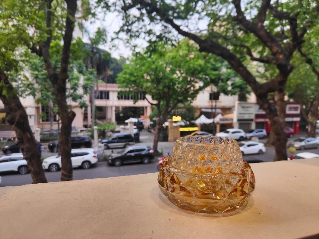 a glass object sitting on top of a ledge with a city at Boulevard Rollandes house in Hanoi