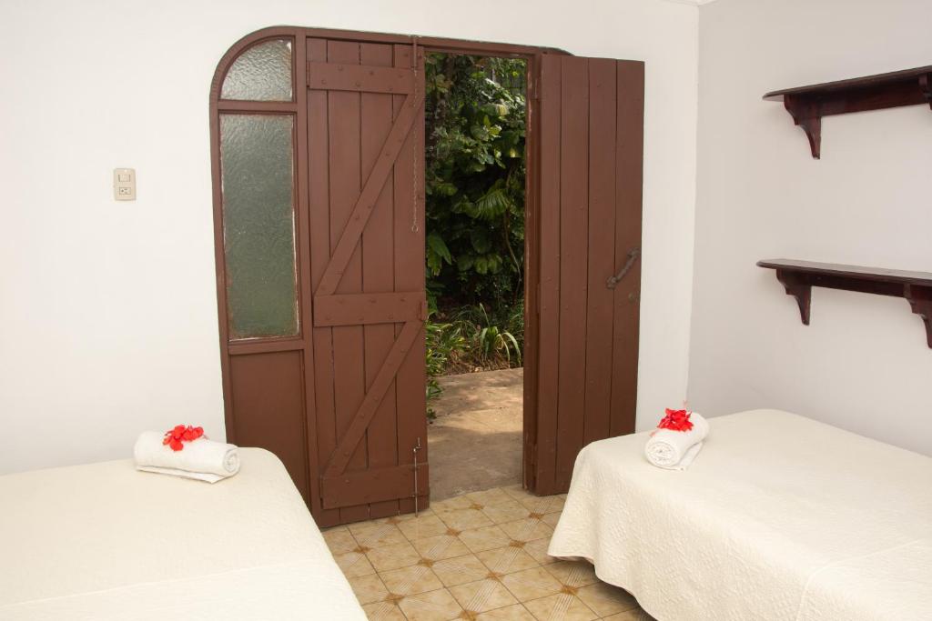 a room with two beds and an open door at Casa Carmen in Santiago Este