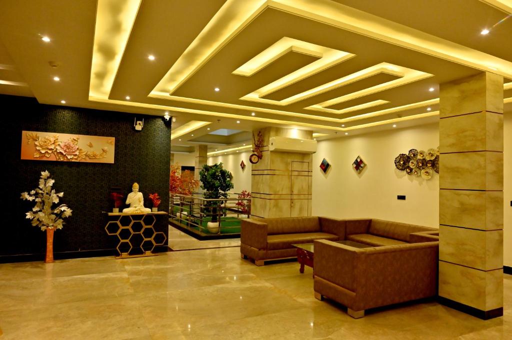 a lobby with couches and a table in a building at Hotel Elite in Amritsar