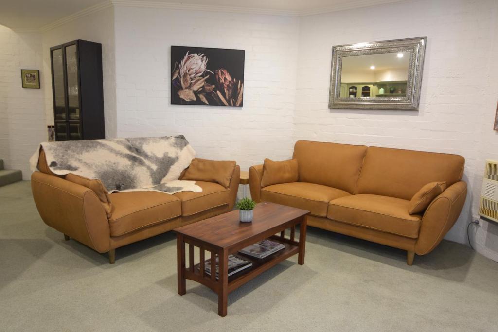 a living room with two couches and a coffee table at Beehive 14 in Mount Buller