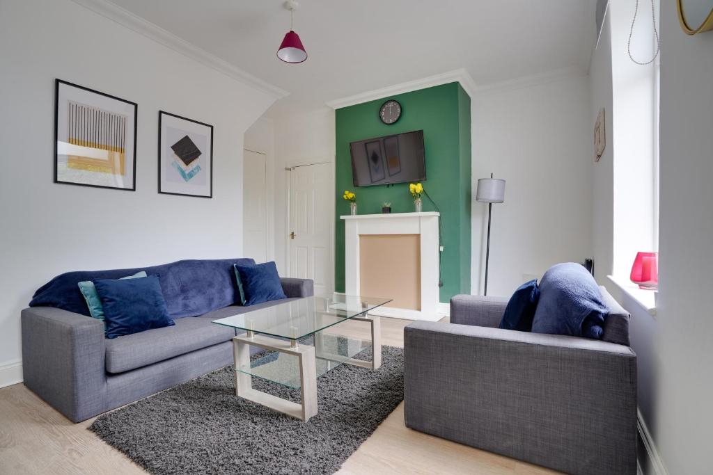a living room with two couches and a table at Modern and Spacious 3-Bedroom House - Free Parking, Fast Wi-Fi, Ideal for up to 7 Guests in Houghton le Spring