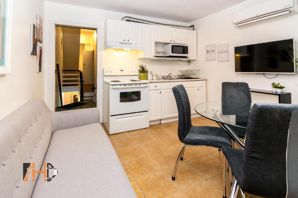 a living room with a table and a kitchen at Downtown Retreat-Spacious Rooms with Shared Kitchen & Bath in Toronto