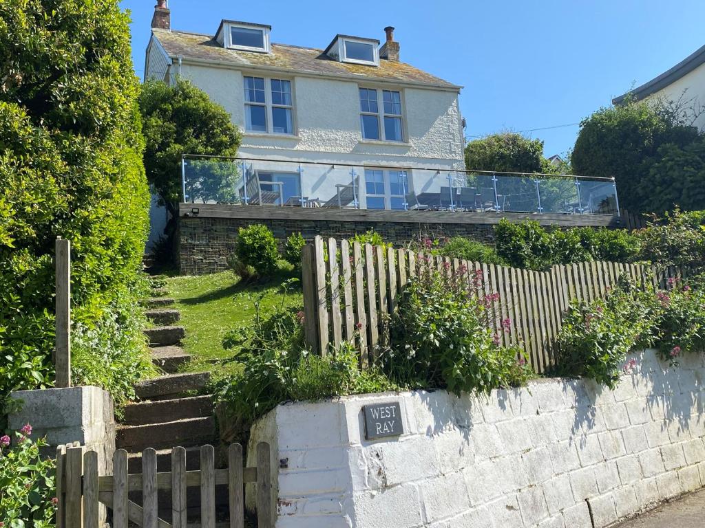 a house with a fence in front of it at Westray House in Polzeath