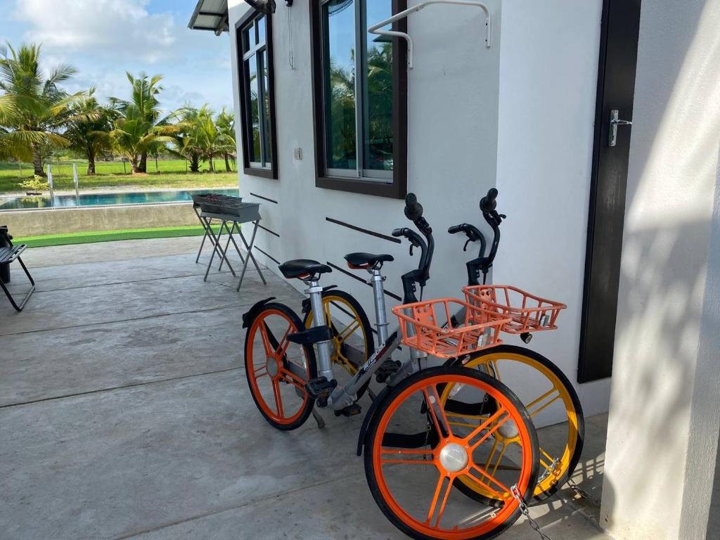 a bike parked next to a building with birds on it at Kuala Kedah Pool Cottage in Kuala Kedah