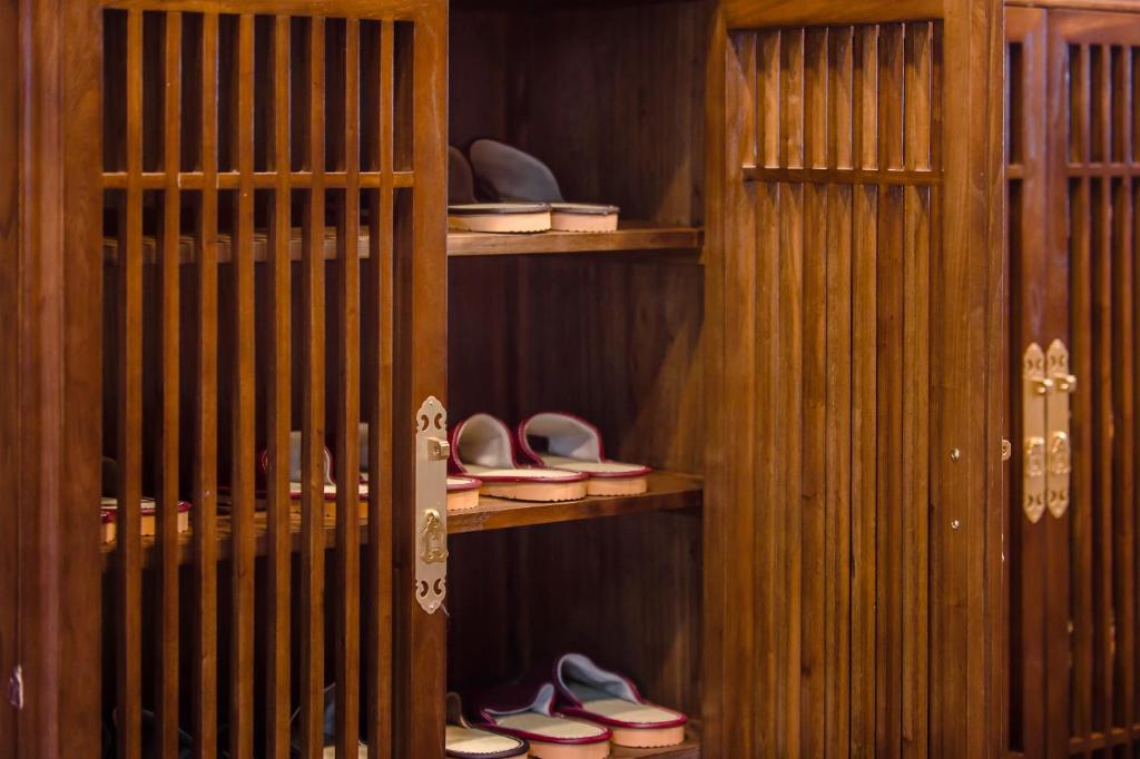 a room with wooden shelves with shoes on them at H&amp; Jiufen The Dragon Inn in Jiufen