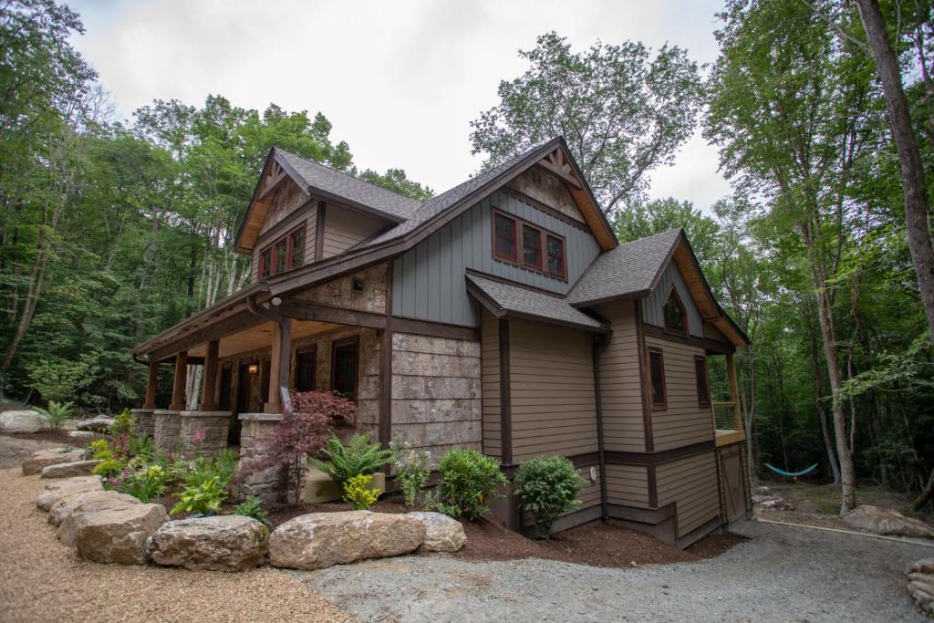a small house in the woods with trees at Red Bird Retreat in Beech Mountain