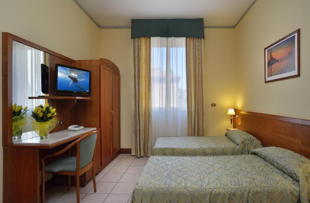 Posteľ alebo postele v izbe v ubytovaní Astor Hotel