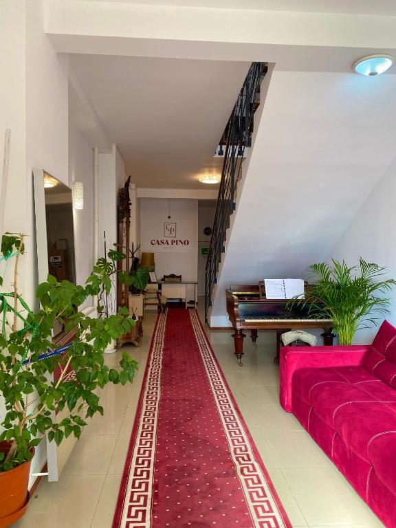 a living room with a red couch and a red rug at Casa Pino in Braşov