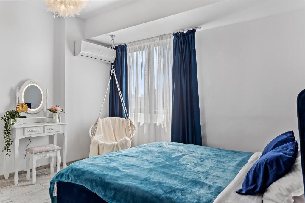 a bedroom with a bed and a desk and a window at Cozy Special City Center - Old Town Apartment with terrace in Bucharest